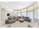 Spacious living room with a large sofa, large windows, and a view to the kitchen at 1274 Prince Ct, Lake Mary, FL 32746