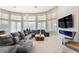 Expansive living room with panoramic windows, cozy seating, modern fireplace, and stylish decor at 1274 Prince Ct, Lake Mary, FL 32746
