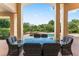 Inviting outdoor patio with seating area overlooking pool and garden, perfect for entertaining and relaxation at 1274 Prince Ct, Lake Mary, FL 32746