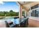 Inviting covered patio with a glass table and chairs overlooking the sparkling pool and lush landscaping at 1274 Prince Ct, Lake Mary, FL 32746