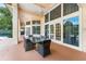 Covered patio with large windows, elegant dining set, offering a perfect blend of indoor-outdoor living at 1274 Prince Ct, Lake Mary, FL 32746