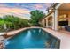 Inviting pool with waterfall feature, surrounded by lush landscaping, and a spacious patio at 1274 Prince Ct, Lake Mary, FL 32746