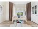 Charming sitting area with neutral tones, modern chairs, and lots of natural light from the French doors at 1274 Prince Ct, Lake Mary, FL 32746