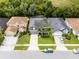 This is a beautiful aerial view showcasing a home with a well-manicured lawn and ample driveway space at 13431 Early Frost Cir, Orlando, FL 32828