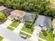Aerial view of a house with manicured front lawn, an inviting driveway, and lovely landscaping at 13431 Early Frost Cir, Orlando, FL 32828