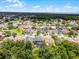 Aerial view of a residential area with various homes and beautiful landscaping surrounded by green trees at 13431 Early Frost Cir, Orlando, FL 32828