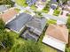 This is an aerial view of a home with a screened-in pool and lush landscaping in a residential neighborhood at 13431 Early Frost Cir, Orlando, FL 32828