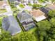 Aerial view of a home featuring a screened-in pool, manicured lawn, and a well-maintained exterior at 13431 Early Frost Cir, Orlando, FL 32828