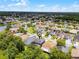 An aerial shot features this home nestled in a beautiful community near a scenic pond at 13431 Early Frost Cir, Orlando, FL 32828