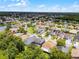 An aerial shot features this home nestled in a beautiful community near a scenic pond at 13431 Early Frost Cir, Orlando, FL 32828