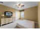 Bedroom featuring a television, neutral walls, carpet, and a large window at 13431 Early Frost Cir, Orlando, FL 32828