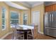Cozy breakfast nook with a round table next to bright windows with blinds at 13431 Early Frost Cir, Orlando, FL 32828
