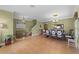 Open-concept living and dining area with decorative lighting and ceramic tile floors at 13431 Early Frost Cir, Orlando, FL 32828