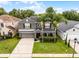 Well-manicured lawn, two-car garage, and a charming front porch at 13431 Early Frost Cir, Orlando, FL 32828