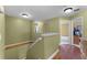 Upstairs hallway with hardwood floors and a view into the bedroom at 13431 Early Frost Cir, Orlando, FL 32828