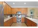 Well-lit kitchen featuring stainless steel appliances, tiled backsplash, and lots of cabinets at 13431 Early Frost Cir, Orlando, FL 32828