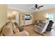 Spacious living room with a ceiling fan, comfortable sofas, and a large window at 13431 Early Frost Cir, Orlando, FL 32828