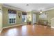 Bright and spacious living room with tile floors, decorative lighting, and large windows at 13431 Early Frost Cir, Orlando, FL 32828