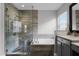 Updated main bathroom featuring a soaking tub and glass-enclosed shower with stylish fixtures at 13431 Early Frost Cir, Orlando, FL 32828
