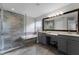 Modern main bathroom featuring dual vanities, a soaking tub, and a glass enclosed shower at 13431 Early Frost Cir, Orlando, FL 32828