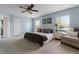 Airy main bedroom with a ceiling fan, two windows, and neutral colored walls at 13431 Early Frost Cir, Orlando, FL 32828
