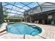 Screened pool area includes outdoor seating area, pool, and a landscaped backyard at 13431 Early Frost Cir, Orlando, FL 32828