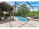 Inviting screened-in pool area with lush greenery, a lounge area, and a relaxing ambiance at 13431 Early Frost Cir, Orlando, FL 32828