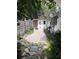 Cozy backyard featuring a charming brick path, shed, and lush greenery at 1420 Knollwood St, Orlando, FL 32804