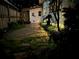 Backyard at night with brick patio and lush landscaping around house at 1420 Knollwood St, Orlando, FL 32804
