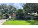 Beautifully landscaped property showcases lush greenery and a well-maintained lawn surrounding the charming home at 1420 Knollwood St, Orlando, FL 32804
