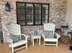 Relaxing front porch setting with comfortable seating, a window, and decorative accents on brick at 1420 Knollwood St, Orlando, FL 32804