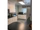 Bright kitchen with white cabinets, black countertops, and tiled floors at 1420 Knollwood St, Orlando, FL 32804