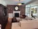 Elegant living room features a brick fireplace, comfortable seating, and seamless flow to other areas at 1420 Knollwood St, Orlando, FL 32804