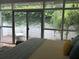 Main bedroom with sliding glass door to backyard, with lush exterior scenery at 1420 Knollwood St, Orlando, FL 32804