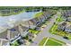 Aerial view of lakeside townhomes showing well-kept lawns and neat streets, promising serene living at 15577 Willow Arbor Cir, Orlando, FL 32824