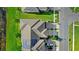 Top-down aerial view featuring the roof and solar panels of a townhome, with a glimpse of the neighborhood and lake at 15577 Willow Arbor Cir, Orlando, FL 32824