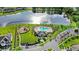 Aerial view of community amenities including a pool, playground, and clubhouse next to a lake at 15577 Willow Arbor Cir, Orlando, FL 32824