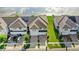 Overhead view of lovely townhomes, green lawns, and peaceful lakeside living at 15577 Willow Arbor Cir, Orlando, FL 32824