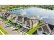 Beautiful aerial view of townhomes near a lake, showcasing lush greenery and neatly arranged residences at 15577 Willow Arbor Cir, Orlando, FL 32824