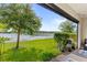 Picturesque backyard view of lush greenery, lake, and serene landscape, perfect for outdoor enjoyment at 15577 Willow Arbor Cir, Orlando, FL 32824