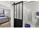 Bedroom with sliding barn door leading to the ensuite bathroom at 15577 Willow Arbor Cir, Orlando, FL 32824
