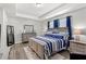 Bright bedroom featuring a bed with blue bedding and a dresser at 15577 Willow Arbor Cir, Orlando, FL 32824