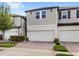 Charming two-story townhome featuring a two-car garage and brick paved driveway at 15577 Willow Arbor Cir, Orlando, FL 32824