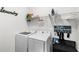 Functional laundry room with modern washer and dryer, shelving, and space-saving accessories at 15577 Willow Arbor Cir, Orlando, FL 32824