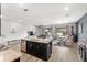 Open-concept kitchen flowing into the living and dining areas, creating a spacious and inviting atmosphere at 15577 Willow Arbor Cir, Orlando, FL 32824