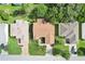 An aerial view shows the home's roof, manicured lawn, driveway, and nearby mature trees at 17097 Se 96Th Chapelwood Cir, The Villages, FL 32162