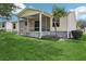 Backyard view with a peaceful screened patio for relaxation at 17097 Se 96Th Chapelwood Cir, The Villages, FL 32162