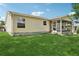 The backyard features lush lawn, and a cozy screened in patio at 17097 Se 96Th Chapelwood Cir, The Villages, FL 32162