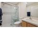 Well-lit bathroom with a shower featuring a sliding door, complemented by a vanity and toilet at 17097 Se 96Th Chapelwood Cir, The Villages, FL 32162