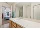 Bright bathroom with a sink vanity adjacent to the bedroom, offering seamless transitions at 17097 Se 96Th Chapelwood Cir, The Villages, FL 32162